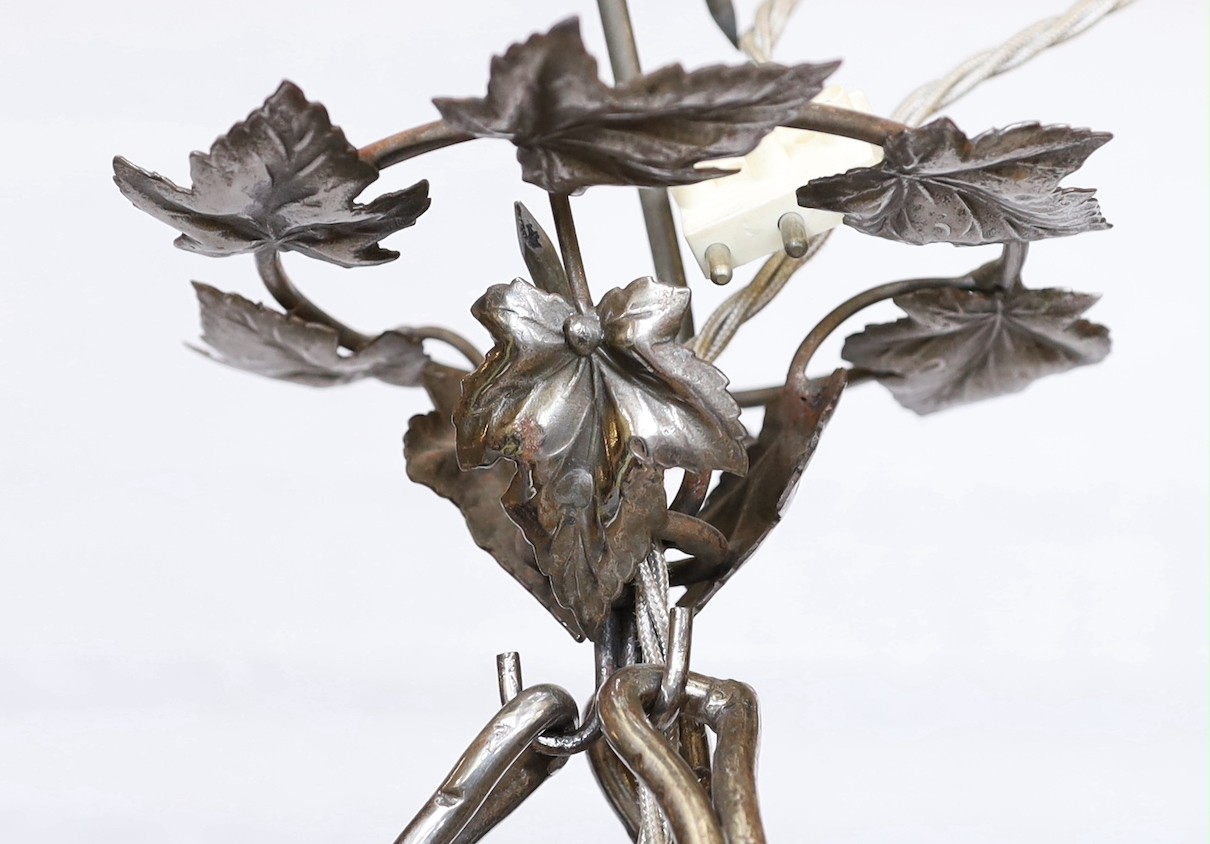 A 1920's-30's French polished wrought iron and marbled glass light fitting decorated with foliate motifs, drop 90cm, width 40cm